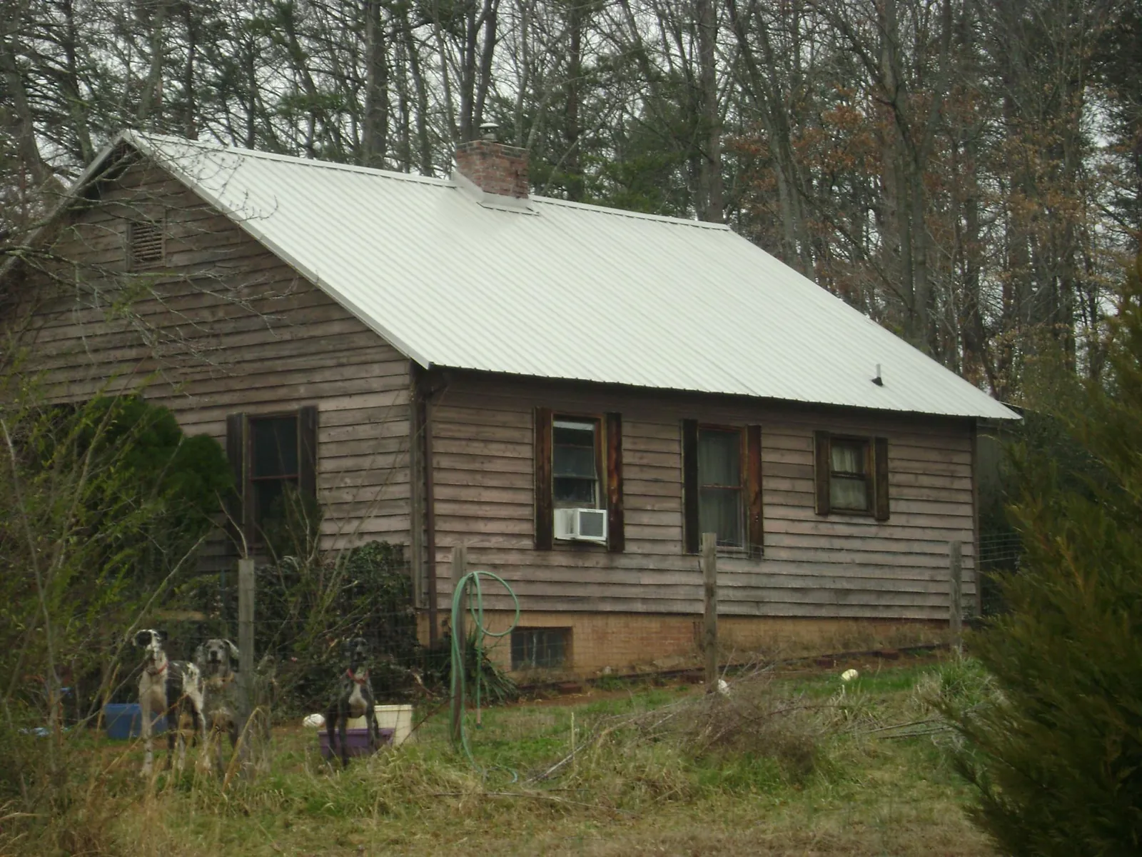 White metal roof on an old wood sided farmhouse, from a Metal Roof Installation job in Bloomingdale